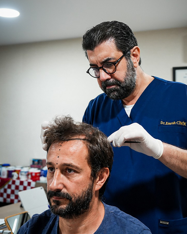 Dr. Emrah Cinik designing a patient's new hairline