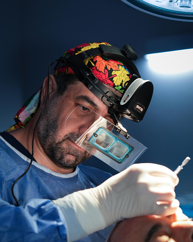 Dr. Emrah Cinik during a hair transplant procedure